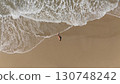Pregnant Woman Relaxing by the Ocean Aerial Beach Photography 130748242