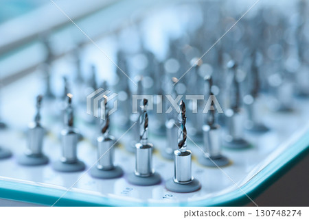 Full set of dental implant drill bits in surgical tray, close-up of professional dentistry equipment 130748274