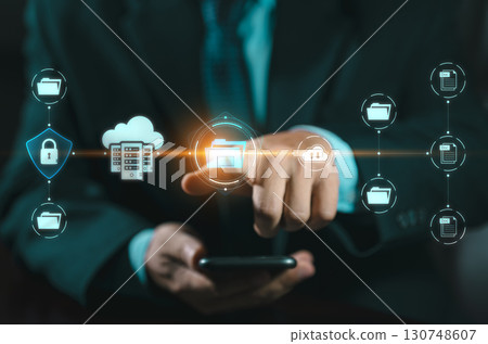 DMS Document Management System concept. Data storage. Businessman using a tablet and touching folder icon to search on databases with virtual screen. documents digital for corporate businesses. DMS Document Management System concept. Data storage. Businessman using a tablet and touching folder icon to search on databases with virtual screen. documents digital for corporate businesses. 130748607