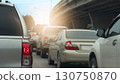 Rear side of pickup car grey color with turn on brake light. Traffic jam in the city. Many cars stop on the road curves under the overpass. with light from front. 130750870