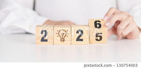 2025 year change to 2026 year block with lightbulb. Business Idea, Creative, Thinking, brainstorm, Goal, Resolution, strategy, plan, Action, change and New Year start concepts 2025 year change to 2026 year block with lightbulb. Business Idea, Creative, Thinking, brainstorm, Goal, Resolution, strategy, plan, Action, change and New Year start concepts 130754003
