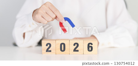 hand holding magnet over 2026 Year block. Human resource management, Recruitment, Teamwork, strategy, toxic people and leadership Concepts 130754012