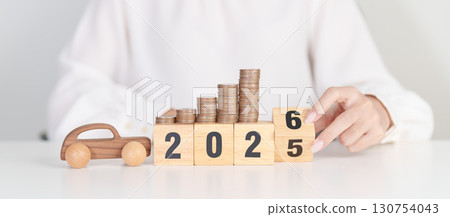 2025 end year to Happy New Year 2026 with car model and Coins Money stack for deposit and Automobile Tax. Money Saving, Car Insurance, Financial, vehicle Repair and Maintenance and New Year concept 130754043