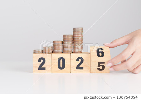 2025 end year to Happy New Year 2026 with Coins stack. Money, Budget, tax, investment, financial, savings and New Year Resolution concepts 130754054
