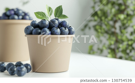 Blueberry fresh fruit on brown paper bowl disposable in white ceramic table 130754539