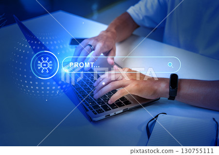 Person typing on a laptop with digital search interface during a creative work session in a modern workspace Person typing on a laptop with digital search interface during a creative work session in a modern workspace 130755111