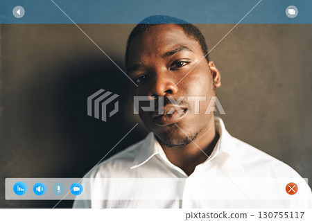 Confident young man posing indoors with a serene expression in a neutral-toned setting Confident young man posing indoors with a serene expression in a neutral-toned setting 130755117