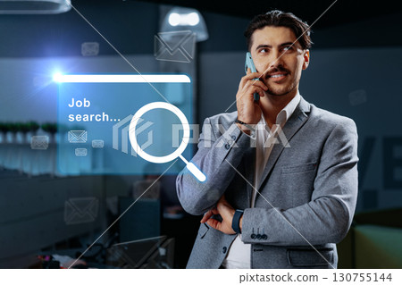 Business professional engaged in job search while on phone in office setting with digital icons around 130755144
