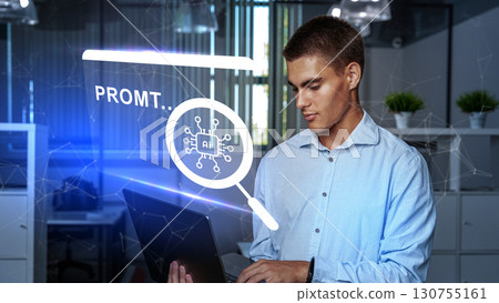 Young man working with laptop in modern office while exploring artificial intelligence applications Young man working with laptop in modern office while exploring artificial intelligence applications 130755161