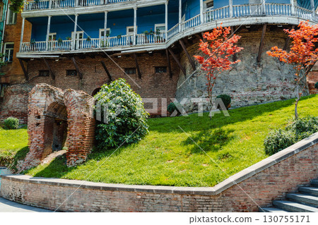Historic architecture with colorful trees and green lawn in Tbilisi, Georgia during a clear sunny day 130755171