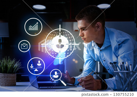 Young professional analyzing data on laptop with digital icons in modern office environment Young professional analyzing data on laptop with digital icons in modern office environment 130755210