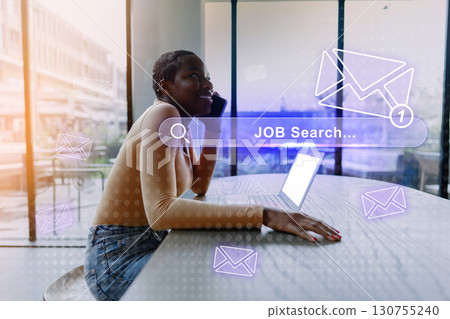 Searching for job opportunities at a modern workspace while on the phone 130755240