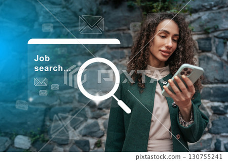 Woman engaging in job search using smartphone in an outdoor urban setting during the day 130755241