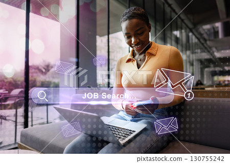 Young woman engaged in a job search using a laptop in a modern workspace during daytime 130755242
