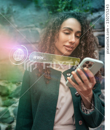 Woman searching online with smartphone in urban setting during daylight Woman searching online with smartphone in urban setting during daylight 130755243