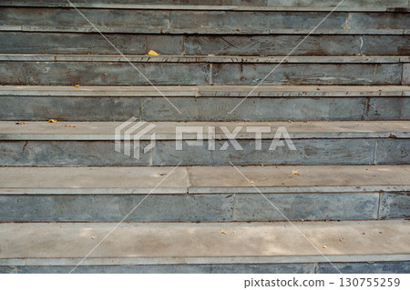 Concrete steps leading up with scattered leaves during autumn in a city park Concrete steps leading up with scattered leaves during autumn in a city park 130755259