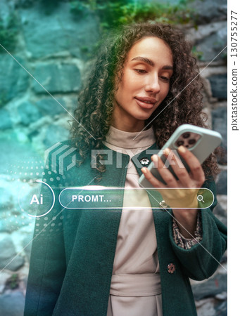 Woman using smartphone outdoors with stone wall backdrop and creative digital overlay showcasing technology 130755277