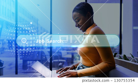 Woman engaging in job search on laptop in a modern workspace during daytime Woman engaging in job search on laptop in a modern workspace during daytime 130755354
