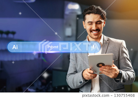 Man using tablet to explore artificial intelligence applications in a modern office setting during daytime 130755408