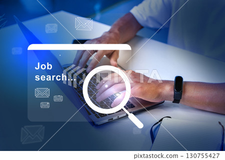 Hands typing on laptop during a job search in an organized workspace with blue lighting in the background 130755427