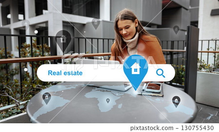 Young woman working on a laptop outdoors while exploring real estate options on a sunny day 130755430