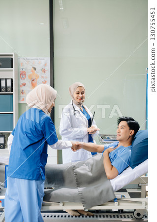 Hospital Ward Female Professional Asian Doctors Talk with a Patient, Give Health Care Advice, Recommend Treatment Plan Hospital Ward Female Professional Asian Doctors Talk with a Patient, Give Health Care Advice, Recommend Treatment Plan 130755451