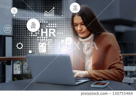 Professional woman engages in remote human resources project in urban workspace during morning hours 130755464