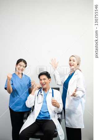 Successful team of medical doctors looking at camera and smiling while standin. Health, professional and people team in white background 130755546