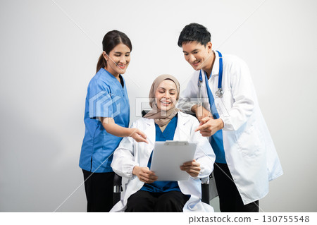 Successful team of medical doctors looking at camera and smiling while standin. Health, professional and people team 130755548
