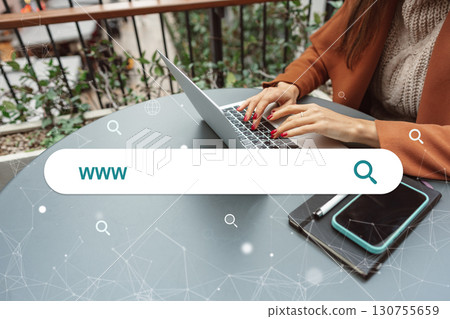 Individual working on laptop at modern cafe table with smartphone and notepad during daytime Individual working on laptop at modern cafe table with smartphone and notepad during daytime 130755659
