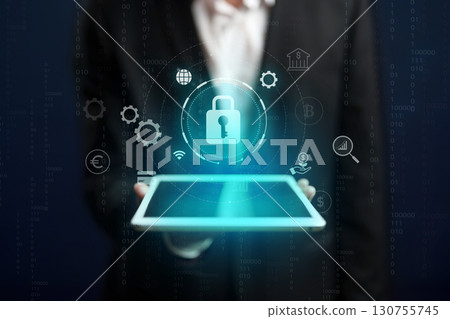 Digital security concepts displayed on a tablet held by a businessman in a suit Digital security concepts displayed on a tablet held by a businessman in a suit 130755745