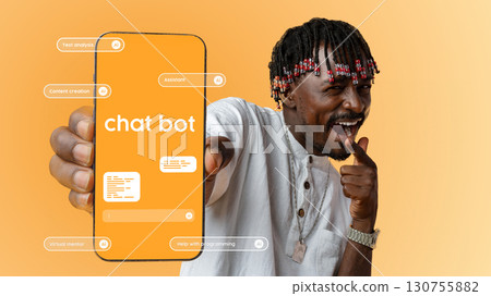 Engaging man showcasing chatbot features on smartphone against orange background in modern tech setup 130755882