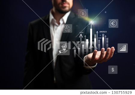 Business professional analyzing cryptocurrency trends and financial data during a digital presentation in an office setting 130755929