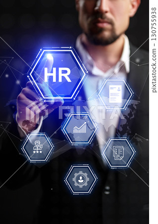 Business professional interacting with human resources digital interface in an office setting during evening hours Business professional interacting with human resources digital interface in an office setting during evening hours 130755938