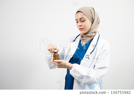 Muslim Arab person. The face of a female doctor on an isolated white background. 130755982