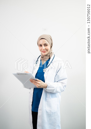 Muslim Arab person. The face of a female doctor on an isolated white background. Muslim Arab person. The face of a female doctor on an isolated white background. 130756012