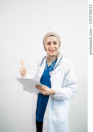 Muslim Arab person. The face of a female doctor on an isolated white background. Muslim Arab person. The face of a female doctor on an isolated white background. 130756013