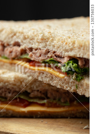 Savory tuna sandwich with fresh lettuce and cheese on whole grain bread served for lunch 130756033