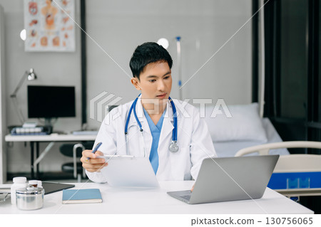 Doctor sit on table in office hospital. Attractive therapist female practitioner pharmacist smile and use tablet and laptop. after success work from treatment Doctor sit on table in office hospital. Attractive therapist female practitioner pharmacist smile and use tablet and laptop. after success work from treatment 130756065