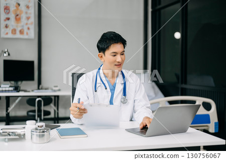 Doctor sit on table in office hospital. Attractive therapist female practitioner pharmacist smile and use tablet and laptop. after success work from treatment Doctor sit on table in office hospital. Attractive therapist female practitioner pharmacist smile and use tablet and laptop. after success work from treatment 130756067