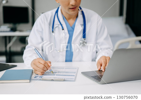 Medical technology concept. Doctor working with mobile phone and stethoscope and digital tablet laptop in modern office at hospital Medical technology concept. Doctor working with mobile phone and stethoscope and digital tablet laptop in modern office at hospital 130756070