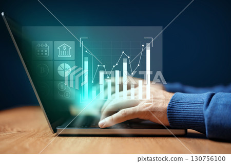 Data analysis and financial metrics displayed on laptop screen with user interaction in a modern workspace Data analysis and financial metrics displayed on laptop screen with user interaction in a modern workspace 130756100