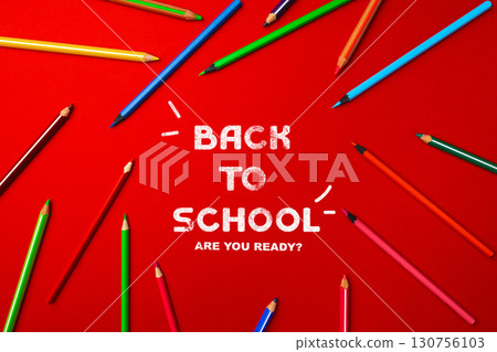 Colorful pencils arranged on a vibrant red background with back to school message for students preparing for new academic year Colorful pencils arranged on a vibrant red background with back to school message for students preparing for new academic year 130756103