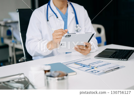 Medical technology concept. Doctor working with mobile phone and stethoscope in office Medical technology concept. Doctor working with mobile phone and stethoscope in office 130756127