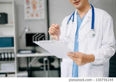 Doctor sit on table in office hospital. Attractive therapist female practitioner pharmacist smile and use tablet and laptop. after success work from treatment Doctor sit on table in office hospital. Attractive therapist female practitioner pharmacist smile and use tablet and laptop. after success work from treatment 130756144