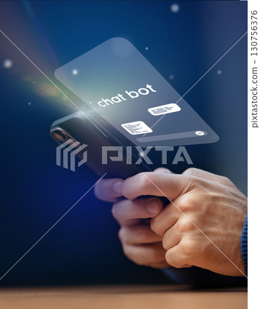 Engaging with chatbot technology on a smartphone in a modern setting after dark 130756376