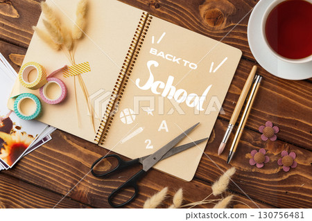 Crafting supplies on a wooden table for a back to school project with a warm drink Crafting supplies on a wooden table for a back to school project with a warm drink 130756481
