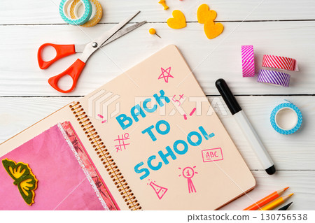 Creative back to school preparation with colorful supplies and stationery on a wooden table Creative back to school preparation with colorful supplies and stationery on a wooden table 130756538