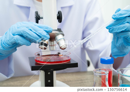 Scientist medical professional use microscope for research in science laboratory. 130756614