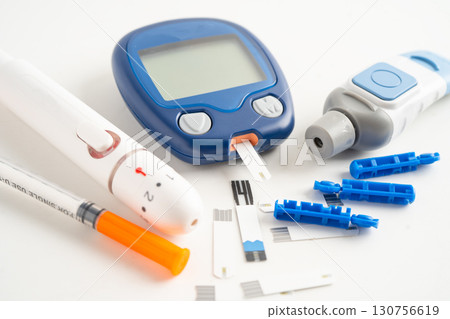 Glucometer lancet and test stick measuring human blood sugar level for diabetes. Glucometer lancet and test stick measuring human blood sugar level for diabetes. 130756619